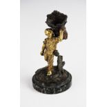 A Grand Tour gilt bronze table vesta, 19th century, modelled as a young boy carrying a wheat