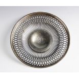A white metal dish, of circular form with pierced decoration border on pedestal foot, with