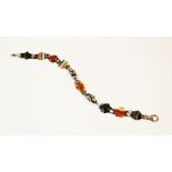 A Victorian 'Scottish' agate and hardstone necklace, comprising eight carved panels of assorted