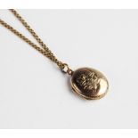 An Edwardian 9ct gold locket pendant, marks for Chester 1901, of oval form with floral bouquet