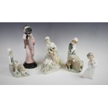 A collection of five Lladro figures, comprising: a young girl with lamb and dog, 22cm high, a