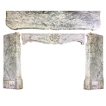 A white and grey variegated marble fire surround