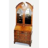 A Queen Anne style walnut bureau bookcase, mid 20th century, with a broken arch moulded pediment