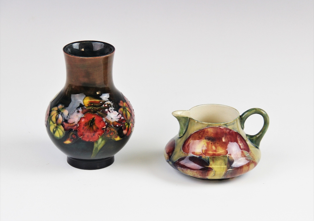 A William Moorcroft cream jug of compressed baluster form, early 20th century, decorated in the - Image 2 of 2