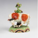 A Staffordshire pearlware cow in the manner of Obadiah Sherratt, early 19th century, modelled