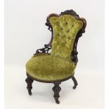 A Victorian walnut and upholstered nursing chair, the shaped button back within a carved 'C'