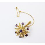 An Edwardian amethyst and seed pearl set starburst brooch pendant, designed as a six pointed star