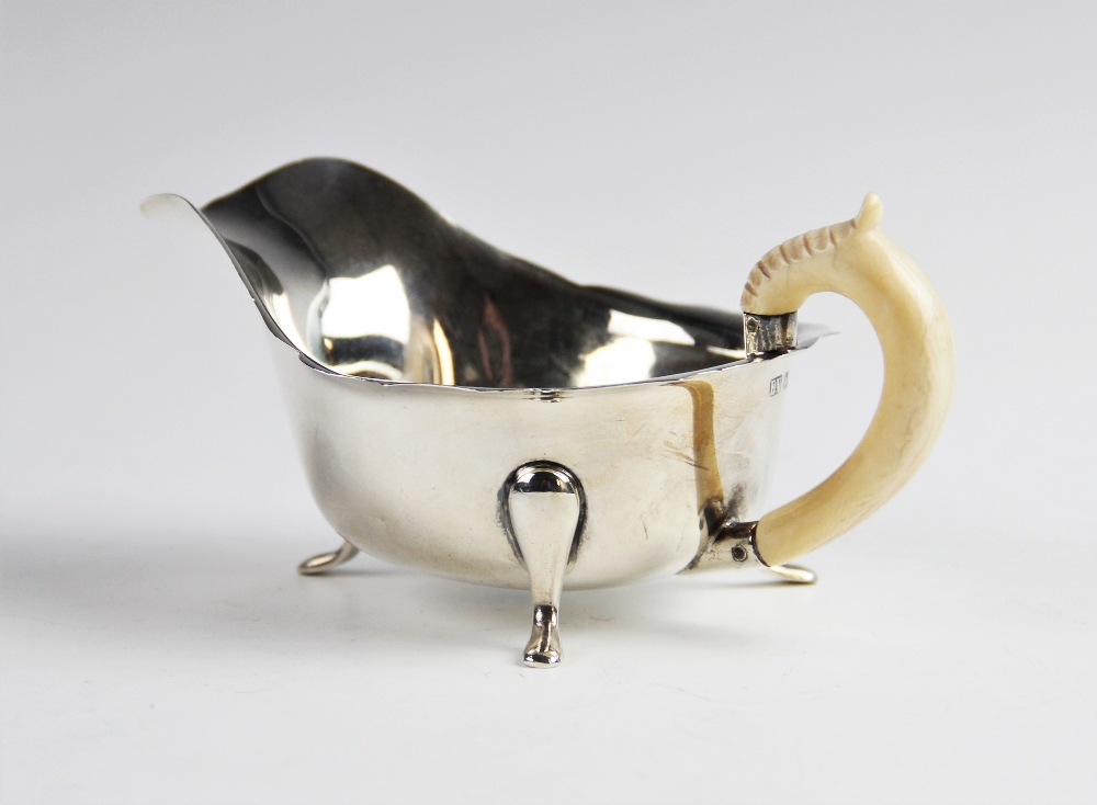 A sauce boat with ivory handle by Emile Viner, Sheffield 1940, of typical form with shaped rim on - Image 2 of 2