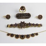 A suite of Bohemian garnet set silver gilt jewellery, to include a pair of floral cluster drop