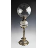 A late 19th century white metal oil lamp by Hinks & Sons, the bubble blown spherical glass shade