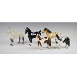 A collection of five Beswick horses, comprising; model 1361 Ch. Black Magic, a Pinto Pony, a Dunn