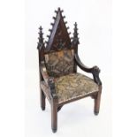 A late 19th century Gothic carved oak Puginesque throne chair, with spire shaped back over down