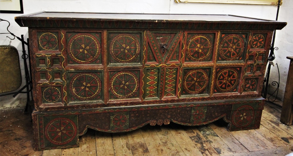 A 19th century Eastern European painted folk art pine chest, painted with geometric designs, the