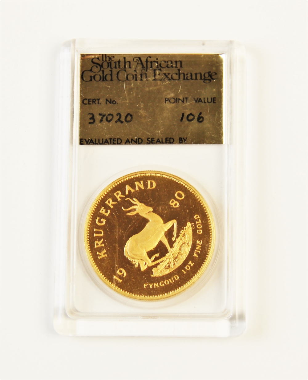 A South Africa Krugerrand 1980, in a plastic display case with evaluation certificate from The South