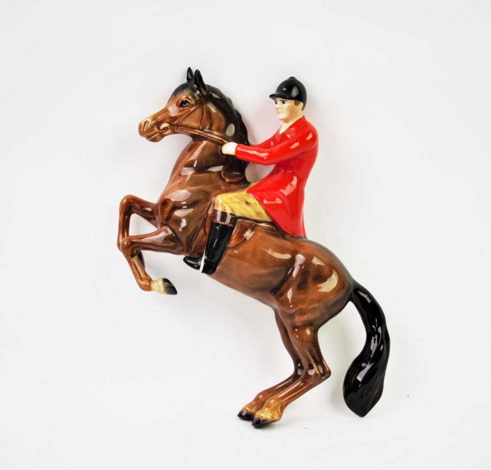 A Beswick wall plaque modelled as a huntsman on rearing horse, model 1505, maker's mark verso,