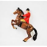 A Beswick wall plaque modelled as a huntsman on rearing horse, model 1505, maker's mark verso,