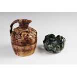 An Arts & Crafts studio pottery pierced vessel, modelled as three grotesque heads, glazed in mottled