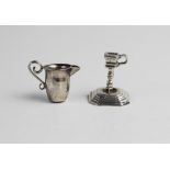 A Dutch silver novelty miniature candlestick, of faceted form with knopped stem on stepped octagonal