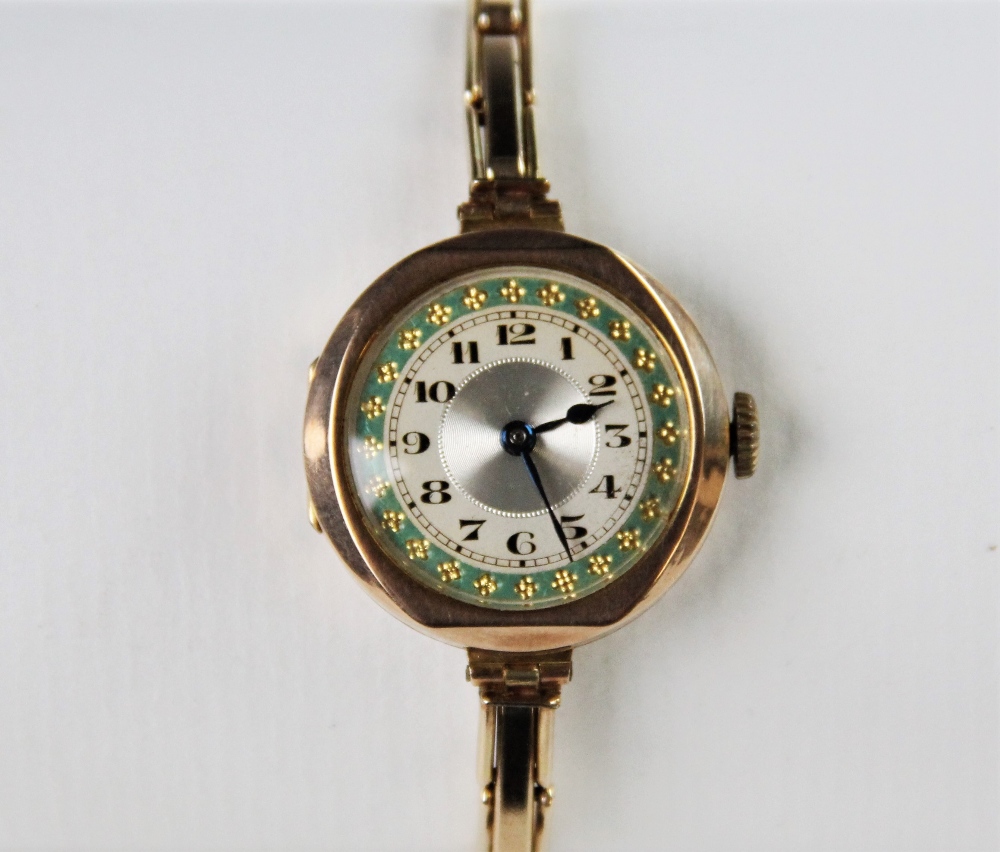 A vintage 9ct gold lady's wristwatch, the round silvered dial with engine turned decoration and