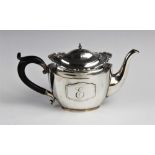 A George V silver teapot by Walker & Hall, Birmingham 1926, of oval faceted form with shaped rim and