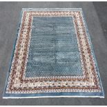 A full pile duck egg blue Persian Sarouk carpet, with Sarouk-mere acorn design, 195cm x 130cm