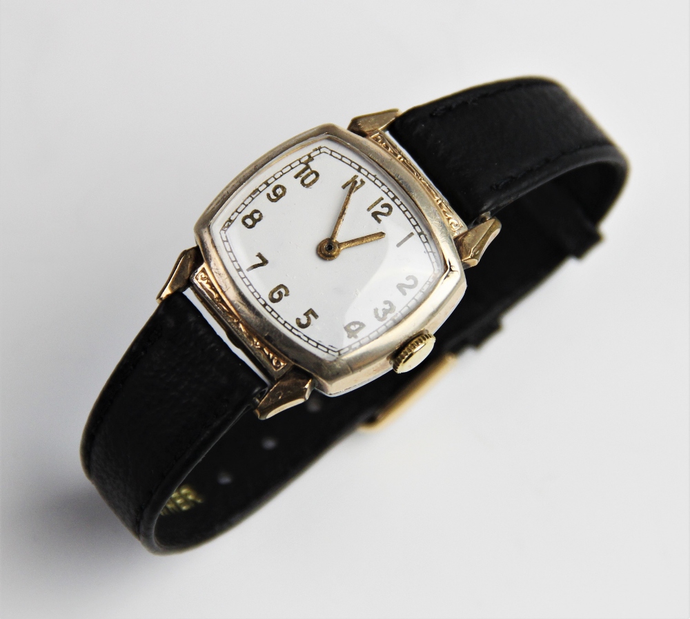 A vintage wristwatch, the white enamel dial with gold toned Arabic numerals and outer seconds track,