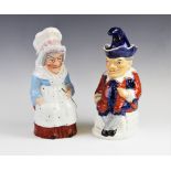 A pair of Punch and Judy toby jugs and covers, late 19th/early 20th century, Mr Punch with red and