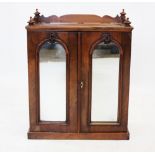 A Victorian walnut specimen cabinet, the rectangular top with turned finials united by a gallery,