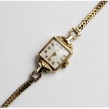 A lady's vintage 9ct gold Tudor wristwatch, the square cream enamelled dial with engine turned