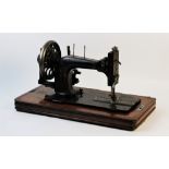 A cased Frister & Rossman hand cranked sewing machine, late 19th/early 20th century, the wooden base