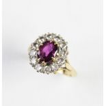 A pink stone and diamond cluster ring, comprising a central untested oval mixed cut stone (