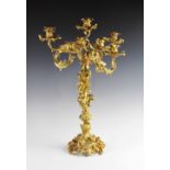 An ormolu six branch candelabrum in the Rococo style, each arm of twisted foliate form with cast