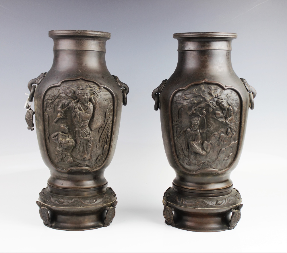 A pair of Japanese bronze vases, late 19th century, each baluster shaped vase modelled upon a