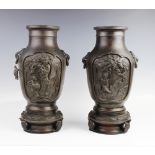 A pair of Japanese bronze vases, late 19th century, each baluster shaped vase modelled upon a