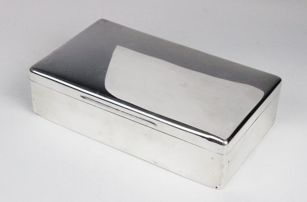 A silver cigarette box by George Henry Cowell, London 1919, of plain polished rectangular form