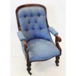 A Victorian mahogany and upholstered open armchair, the button back within a mahogany frame,