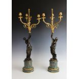 A pair of bronze and gilt metal figural candlesticks, 19th century, each designed as a classical