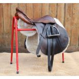 A vintage leather saddle, indistinct makers stamp, 8" wide, 18" seat, with associated leathers and