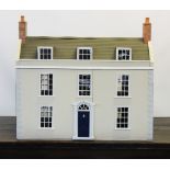 A Georgian style dolls house, late 20th century, the hinged house front with an arrangement of