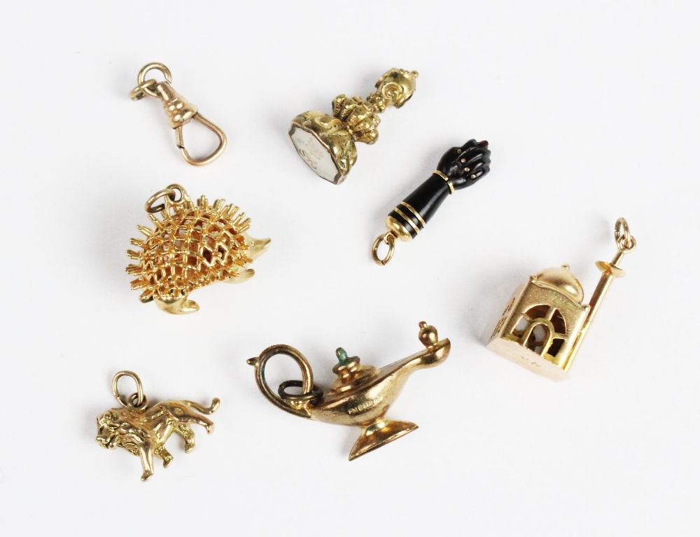 A selection of gold and yellow metal bracelet charms, to include a gold mounted jet coloured figa