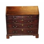 A George III mahogany bureau, the cross banded fall front enclosing a compartmentalised interior