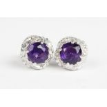 A pair of amethyst set 9ct gold stud earrings, each comprising a round mixed cut amethyst