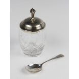 A cut glass preserve jar with silver cover, the jar of baluster form with star cut base, the stepped