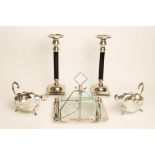 A pair of late 20th century candlesticks, each with plain polished black stems, white metal