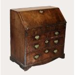 A George III mahogany bureau, the rectangular moulded fall front opening to a compartmentalised