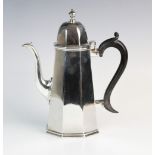 An Edwardian silver coffee pot by Charles Stuart Harris, London 1906, of tapered octagonal form,