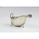 A silver sauce boat by Saunders & Mackenzie, Birmingham 1954, of typical form with gadroon rim and