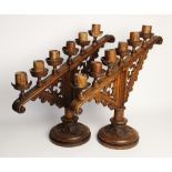 A pair of Puginesque carved wooden six branch ecclesiastical candelabra, late 19th century, of