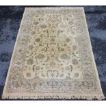 A modern foliate pattern wool rug, the trailing foliate design upon an ivory coloured ground,