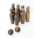 A matched set of nine 19th century fruitwood skittles, each of typical tapering form, 40cm high (